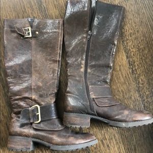 Brown distressed leather below the knee boots.